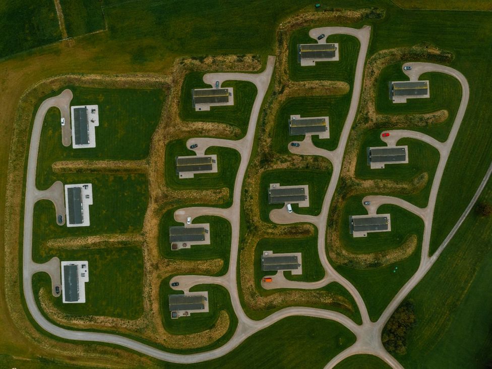 An aerial view of houses and roads in a rural area at Darwin Retreat in Aspatria