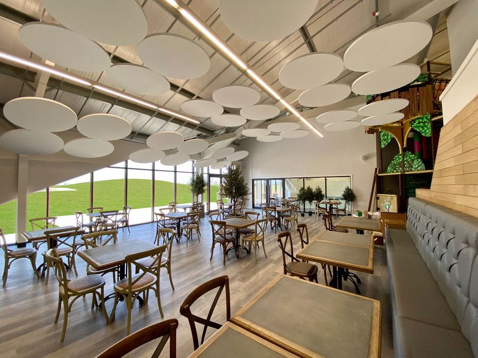 A dining room with tables and chairs at Darwin Retreat in Aspatria