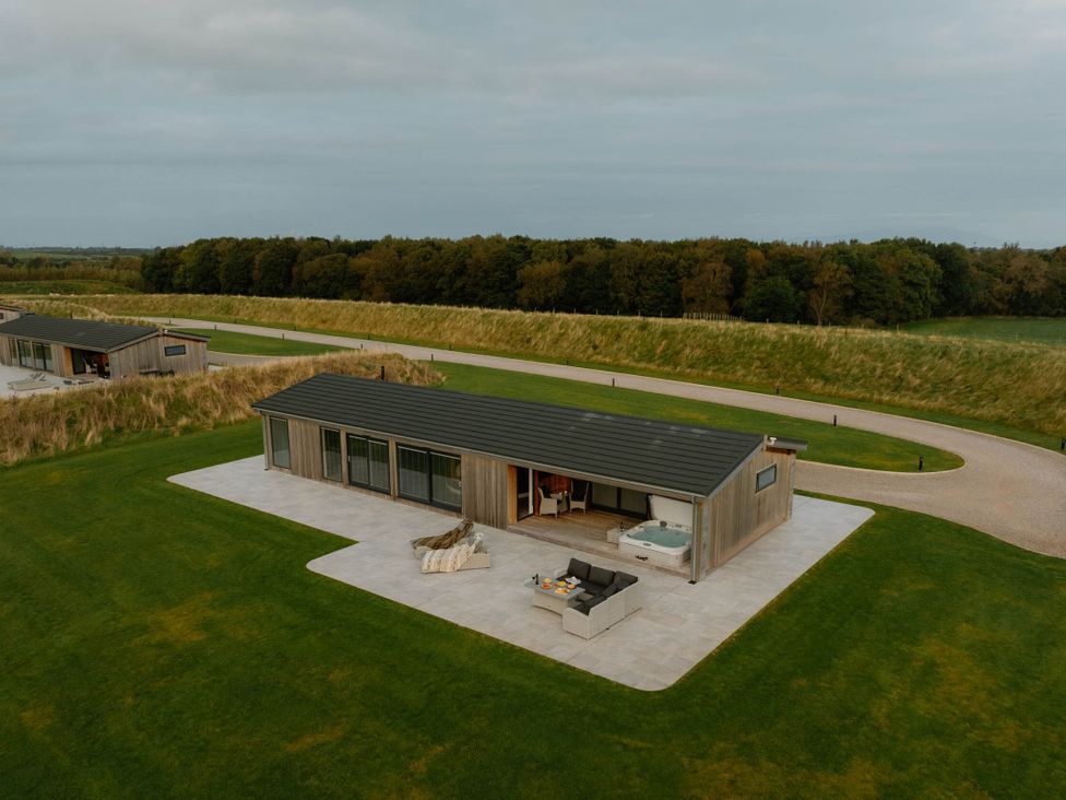 A house with a hot tub and outdoor furniture at The Sheraton Retreat in Wigton
