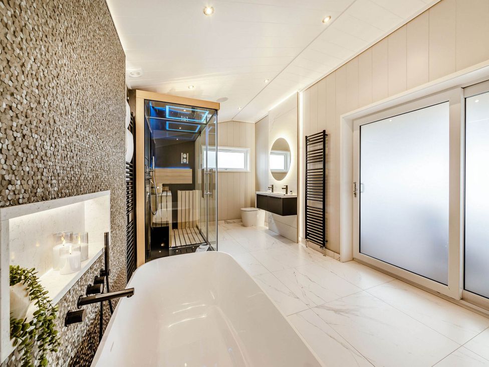A bathroom with a bathtub and shower at The Sheraton Retreat in Wigton