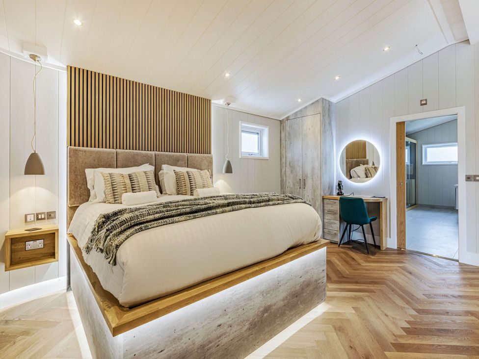 A bedroom with a bed and wardrobe at The Sheraton Retreat in Wigton