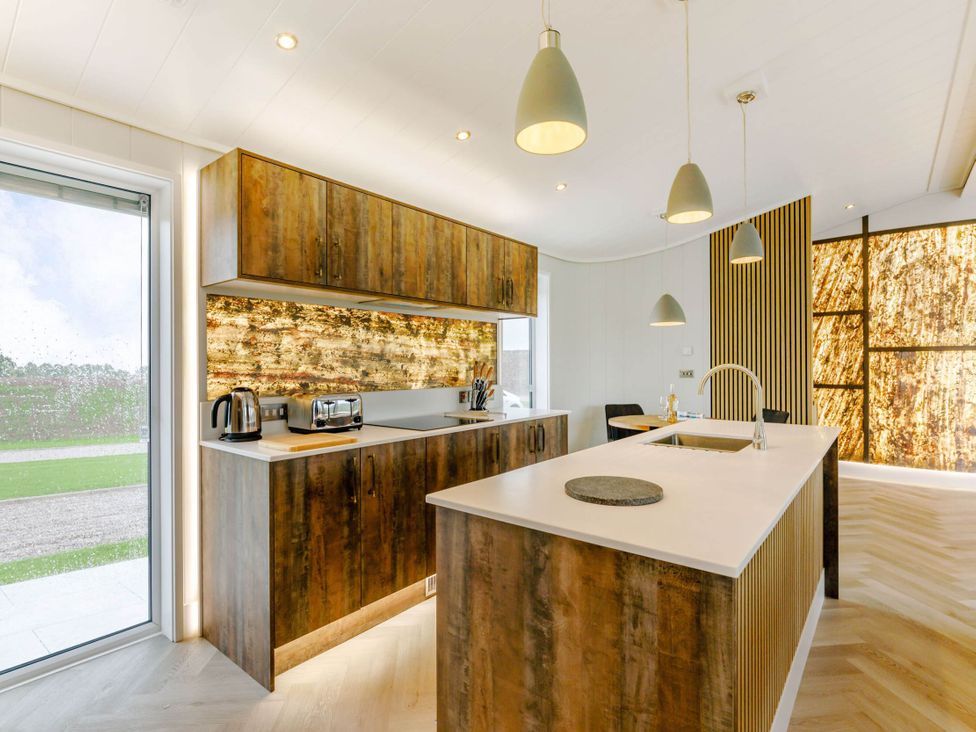 A kitchen with cabinets, sink, and appliances at The Sheraton Retreat in Wigton