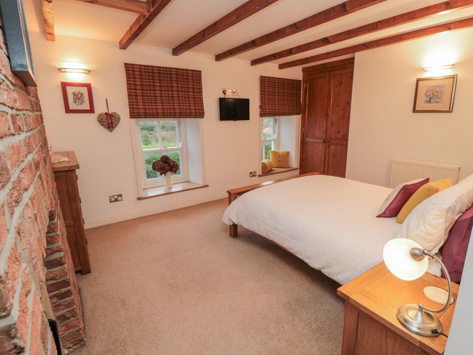 A bedroom with a bed and nightstand at 21 High Street, Scarborough