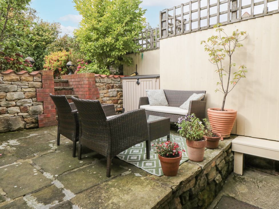 A garden with outdoor seating and plants at 21 High Street Scarborough