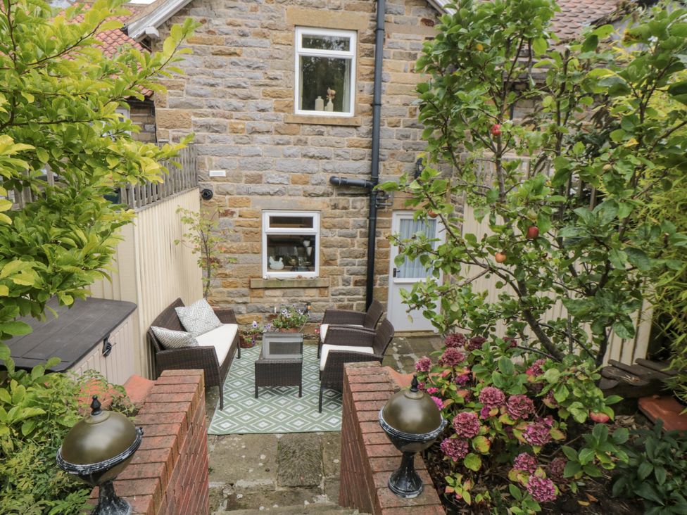 A garden with seating area and plants at 21 High Street Scarborough