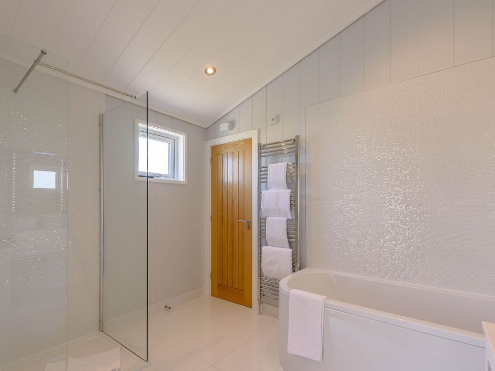 A bathroom with a shower and bathtub at Wordsworth in Wigton