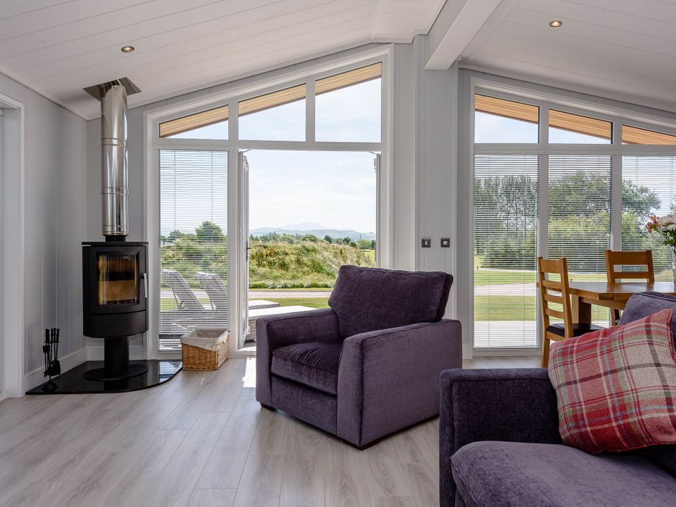 A living room with a stove and seating area at Wordsworth in Wigton