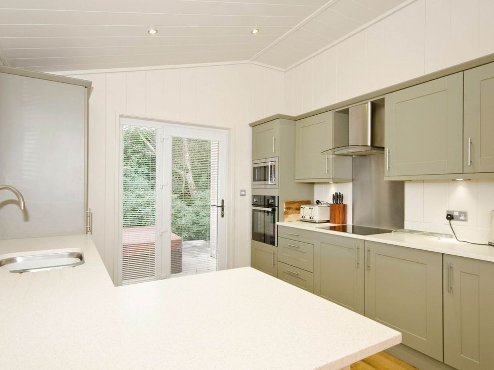 A kitchen with cabinets and appliances at Lawson in Wigton