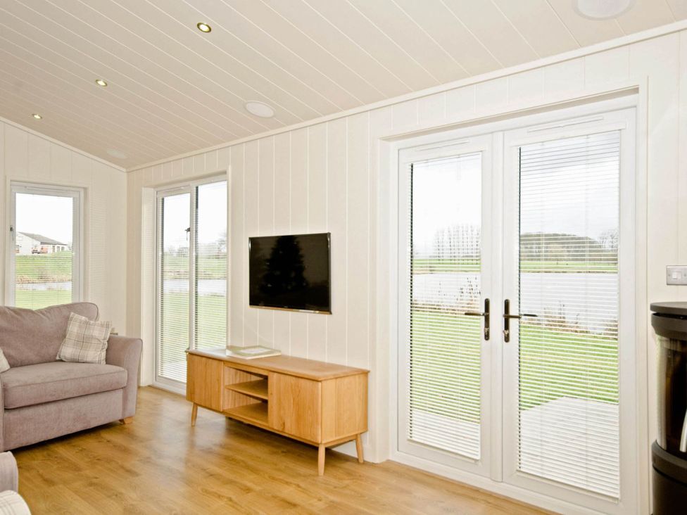 A living room with a sofa and television at Lawson in Wigton