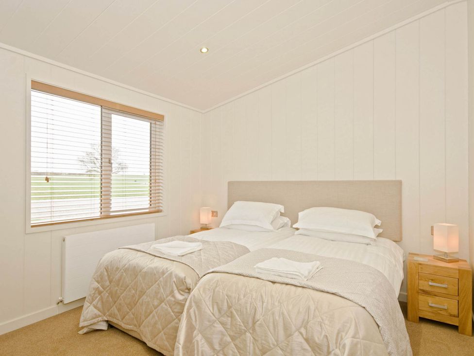 A bedroom with twin beds and a window at Lawson in Wigton