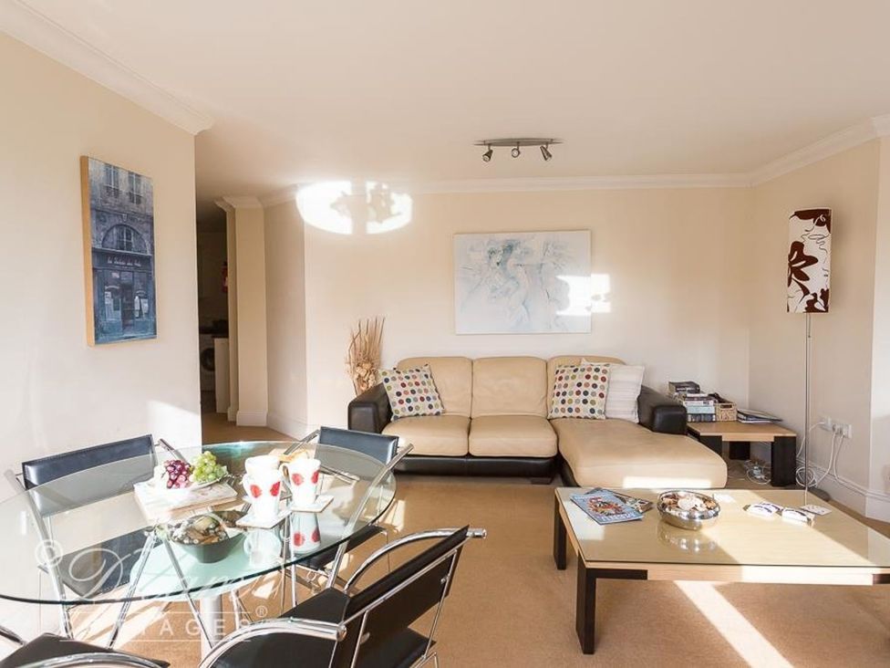 A living room with a sofa and coffee table at Harbourside Apartment in Weymouth