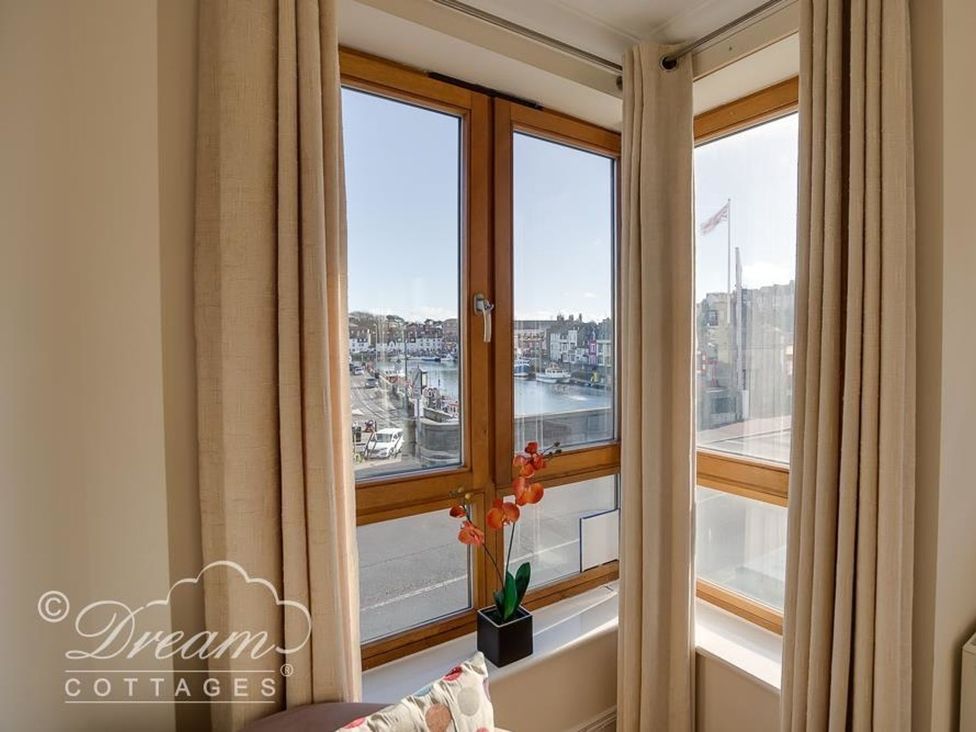 A living room window with a view of the harbor at Harbourside Apartment in Weymouth