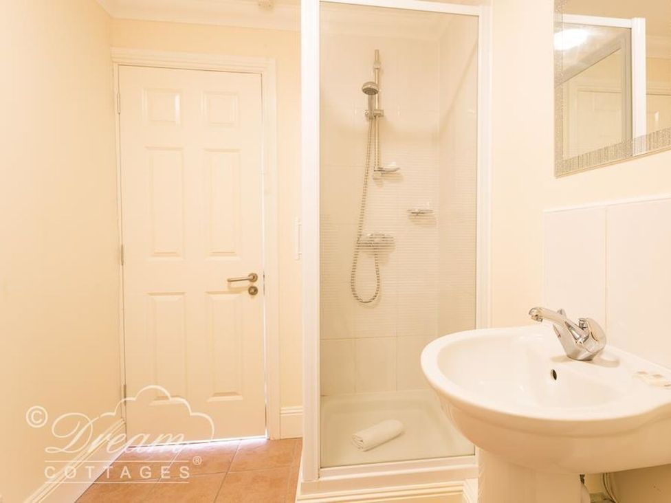 A bathroom with shower and sink at Harbourside Apartment in Weymouth