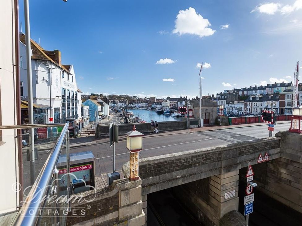 A view of the harbor with boats and buildings at Harbourside Apartment in Weymouth