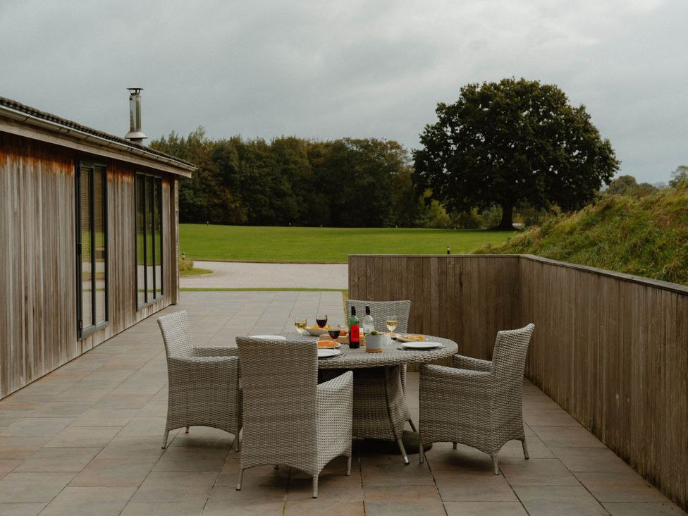 An outdoor seating area with a table and chairs at Wellington in Wigton