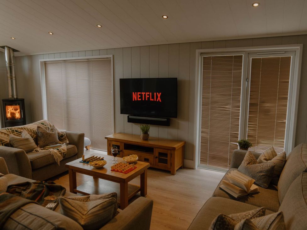A living room with a television and coffee table at Wellington in Wigton