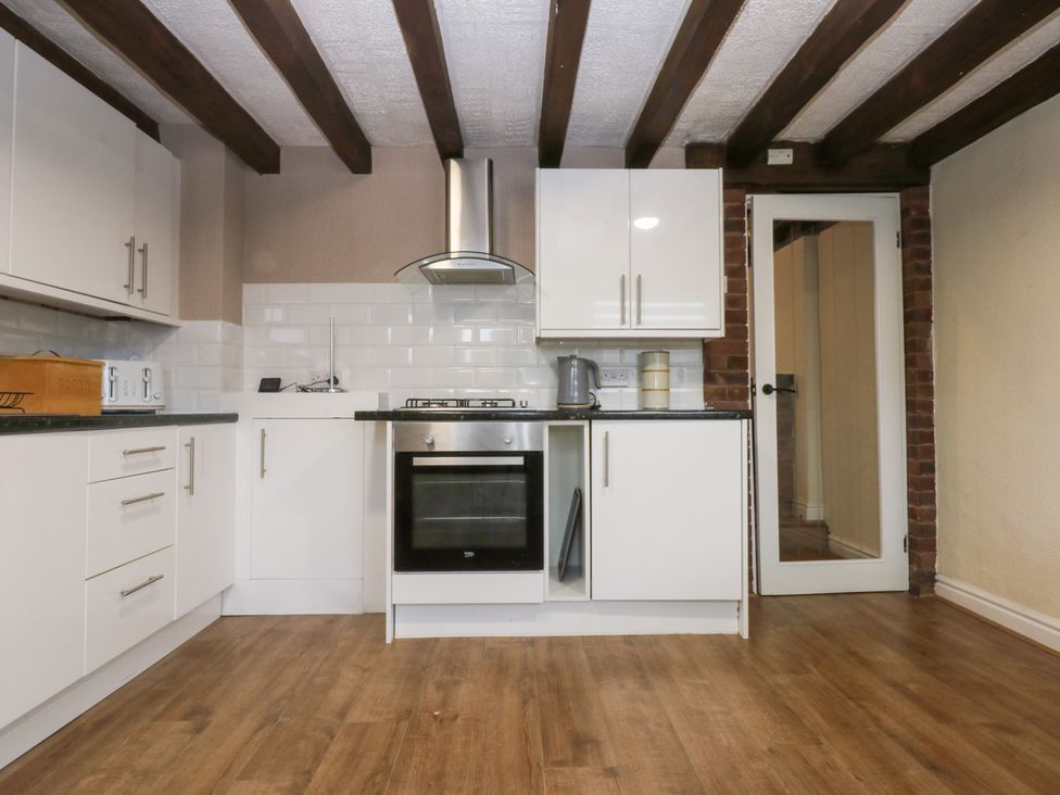 A kitchen with cabinets and appliances at 6 Berry Street in Conwy