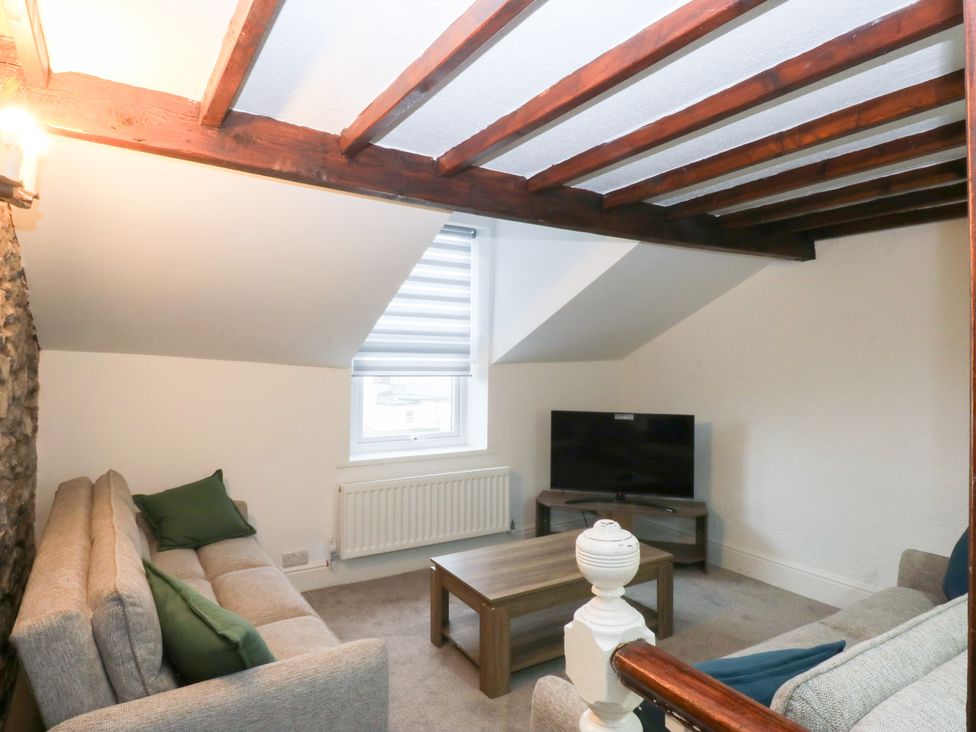 A living room with a coffee table and television at 6 Berry Street, Conwy