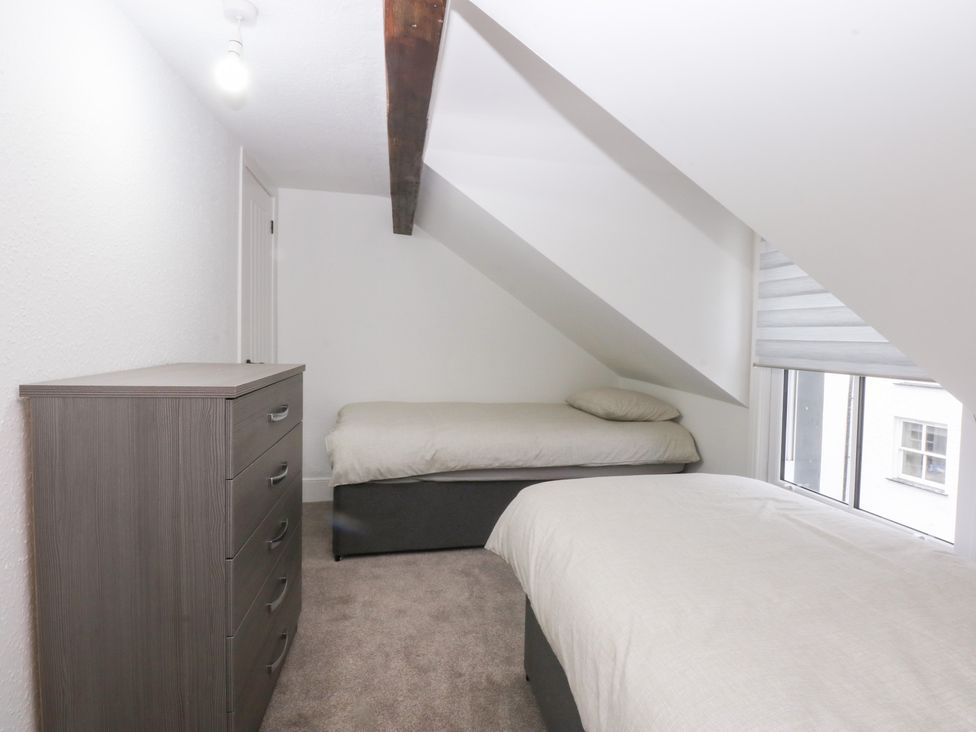 A bedroom with two beds and a dresser at 6 Berry Street Conwy