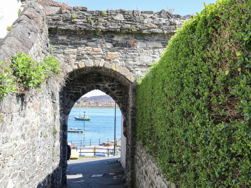 A view through an archway towards a body of water at 6 Berry Street Conwy