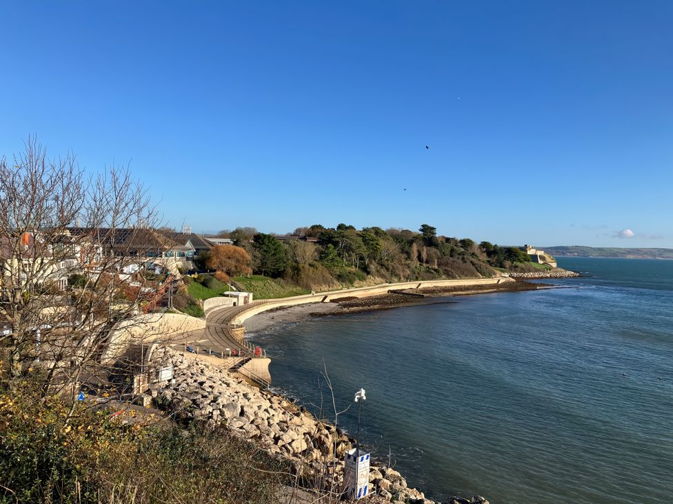 A view of the coastline with houses and trees at 12 Brewhouse Place Weymouth