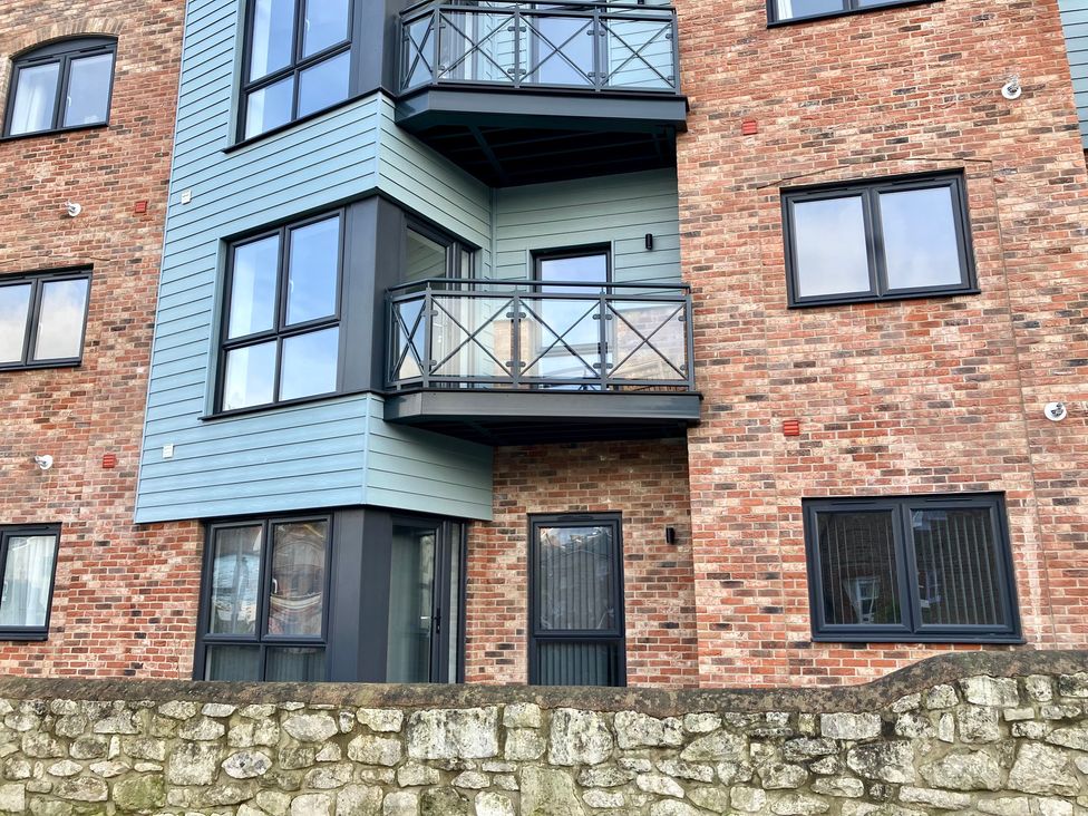 An exterior view of a building with balconies at 12 Brewhouse Place Weymouth