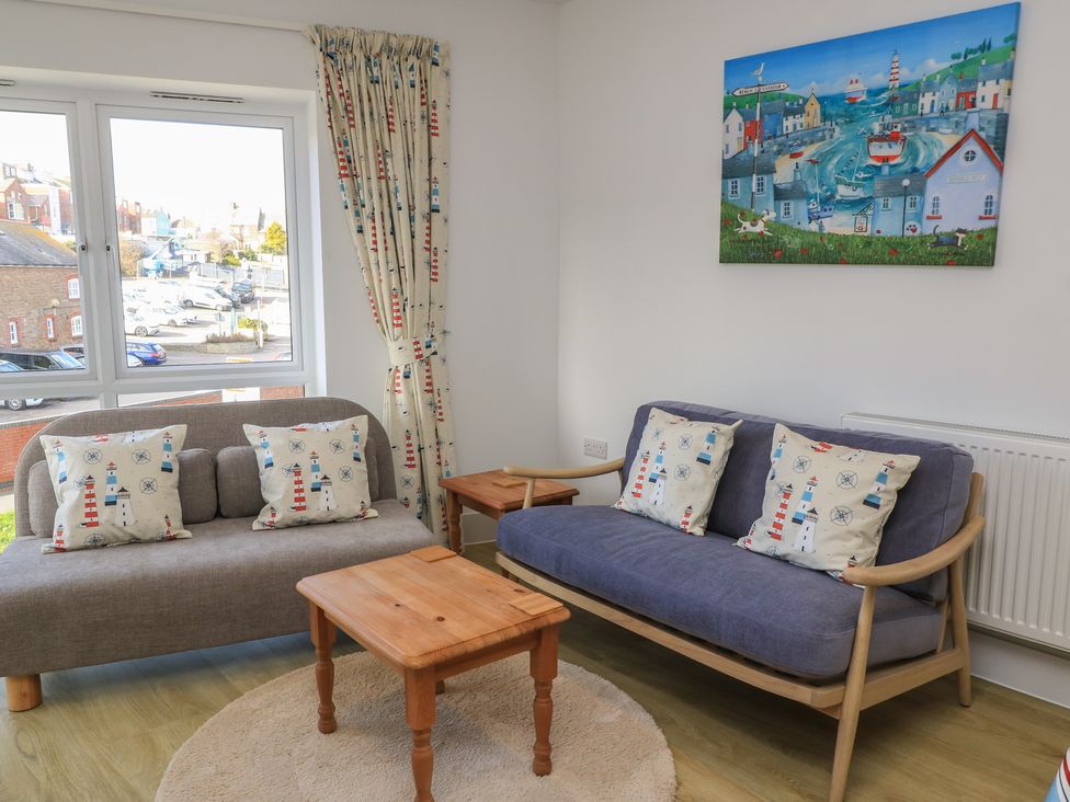 A living room with sofas and a coffee table at Brewery View in Weymouth