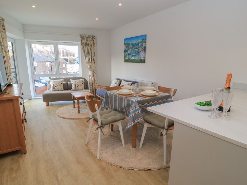 A dining room with a table and chairs at Brewery View in Weymouth