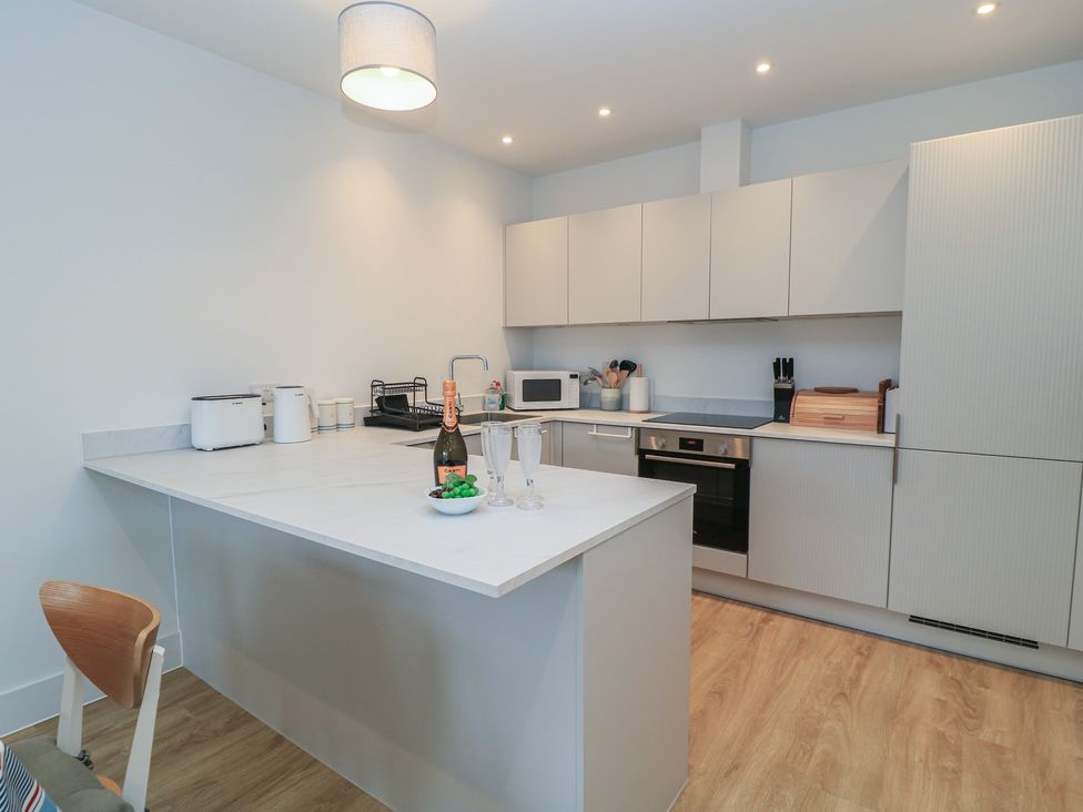A kitchen with modern appliances at Brewery View in Weymouth