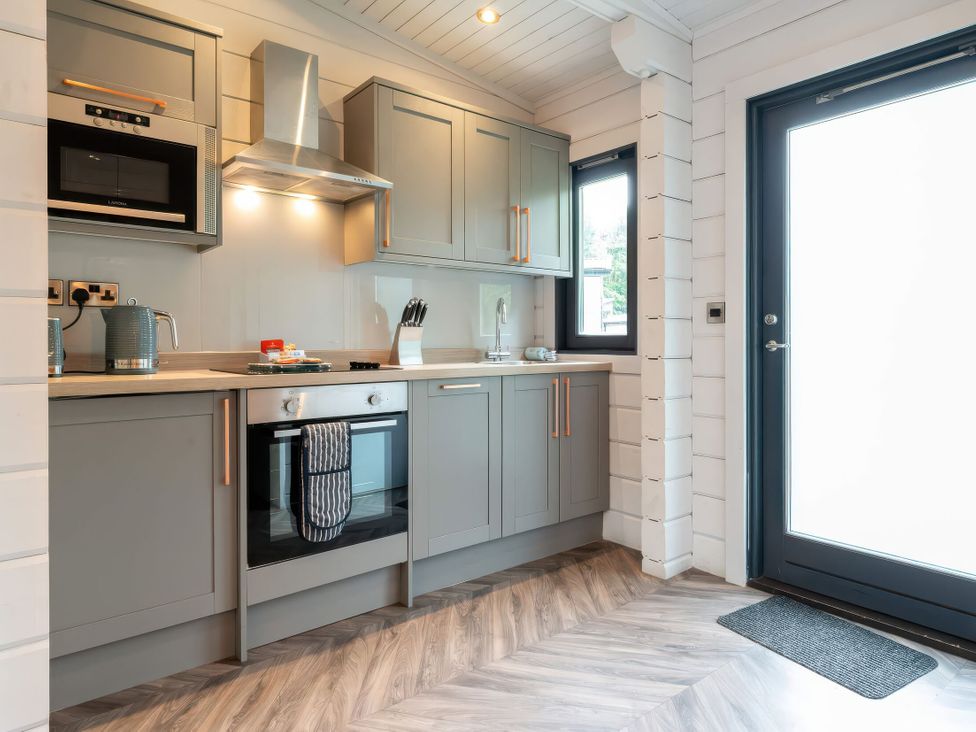 A kitchen with cabinets and appliances at Askrigg (Pet) Aysgarth