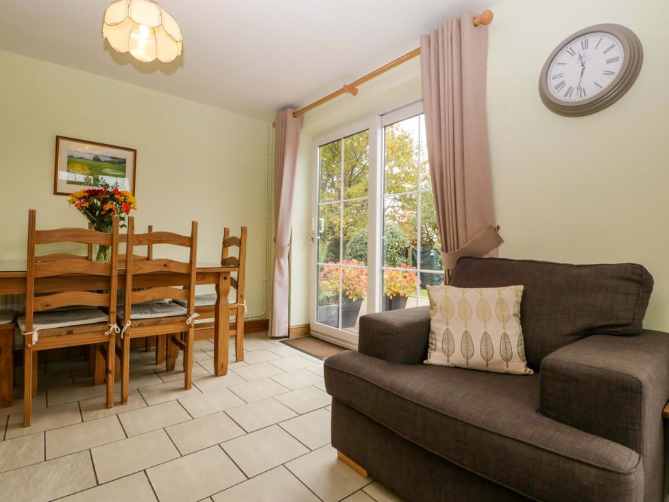 A dining room with a table and chairs at Dovecote Cottage in Corse near Gloucester