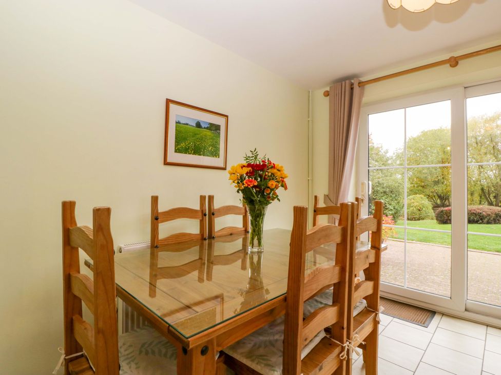A dining room with a table and chairs at Dovecote Cottage Corse near Gloucester