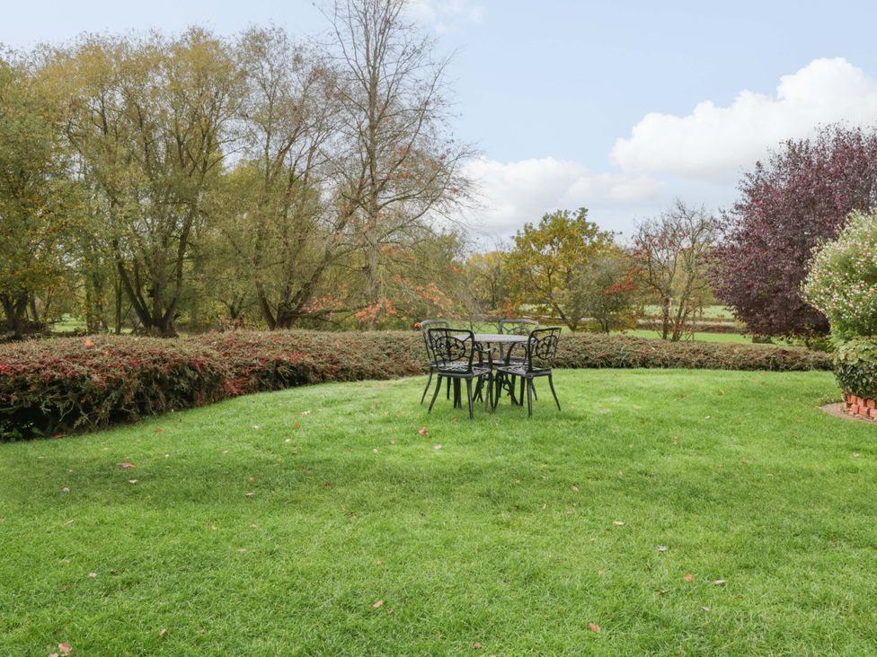 A garden with a table and chairs at Dovecote Cottage in Corse near Gloucester