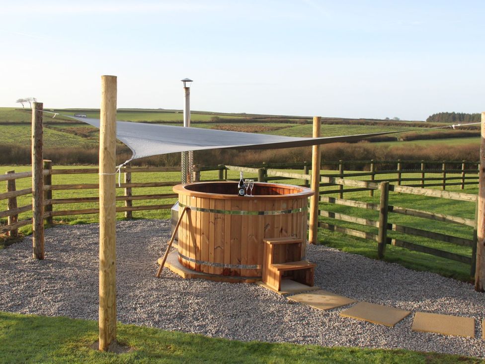 A hot tub with a shelter in an outdoor area at Higher Forda in Holsworthy