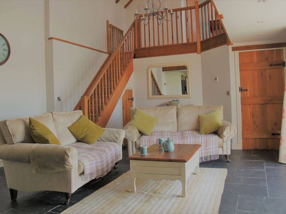 A living room with a sofa and coffee table at Higher Forda in Holsworthy