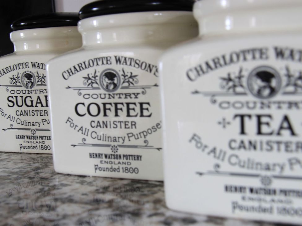 Sugar, coffee, and tea canisters in a kitchen at Higher Forda in Holsworthy