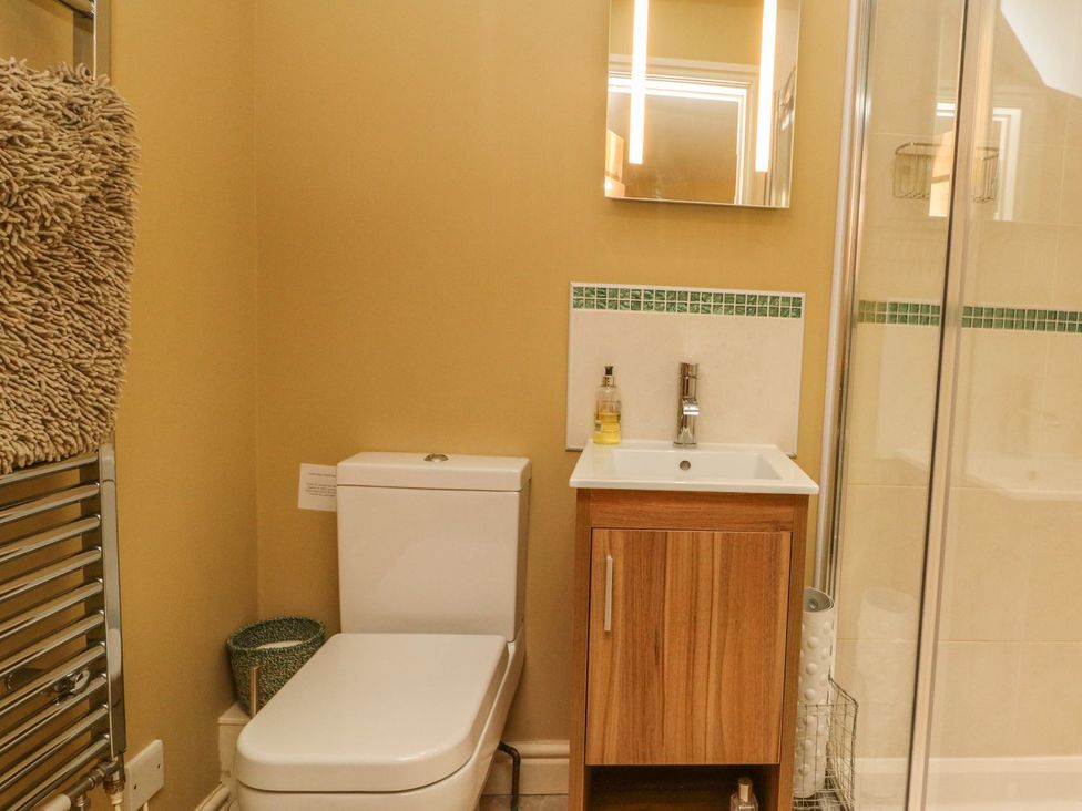 A bathroom with a sink and shower at Higher Forda in Holsworthy