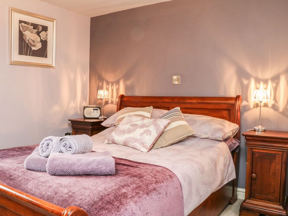A bedroom with bed, pillows and a nightstand at Higher Forda in Holsworthy