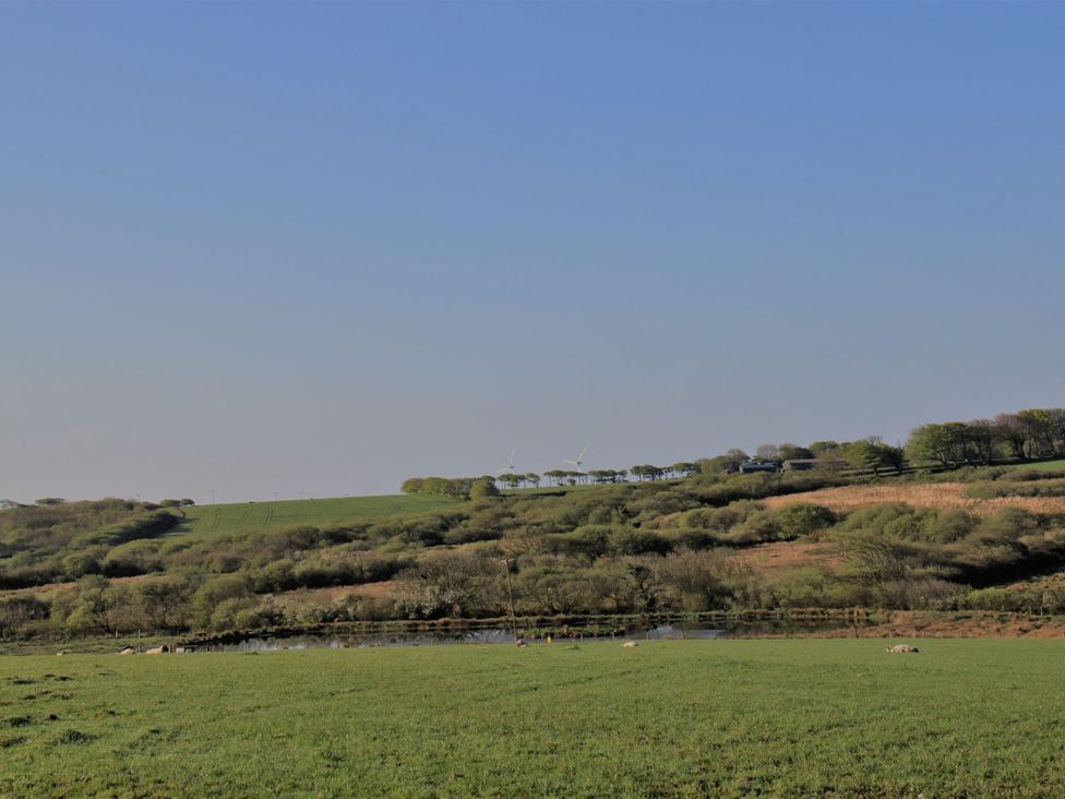 A landscape with hills and wind turbines at Higher Forda in Holsworthy