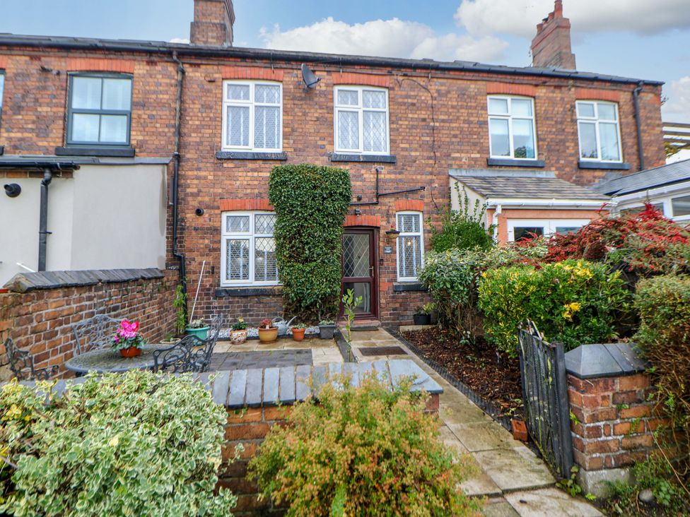 A brick house with a garden and pathway at Shunter’s Nook in Stafford