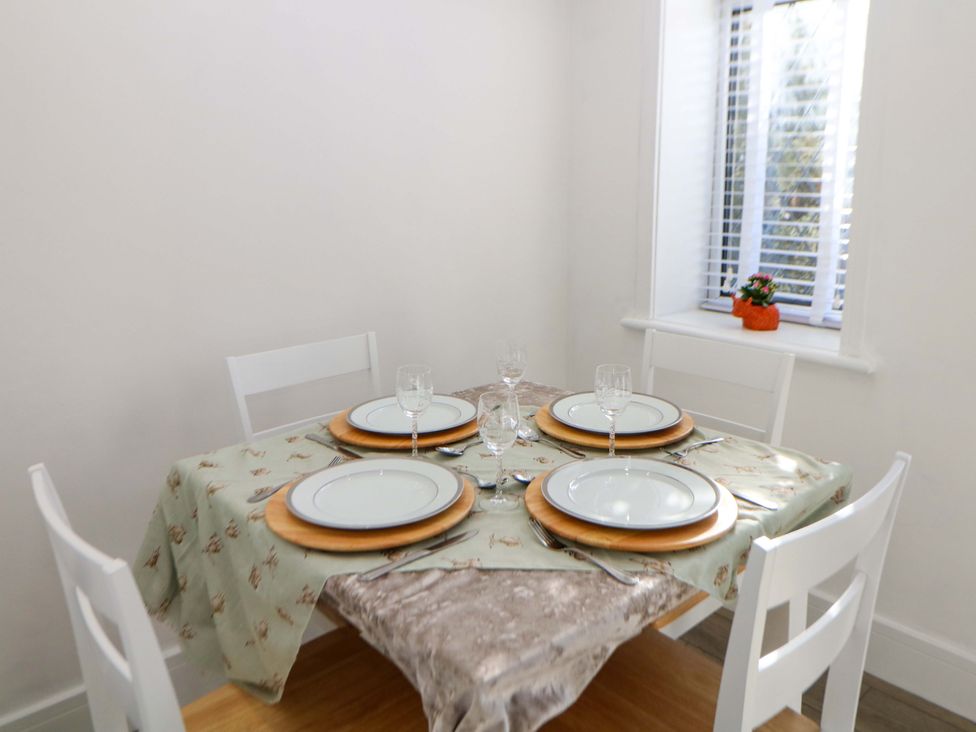 A dining table set with plates and glasses at Shunter’s Nook Stafford