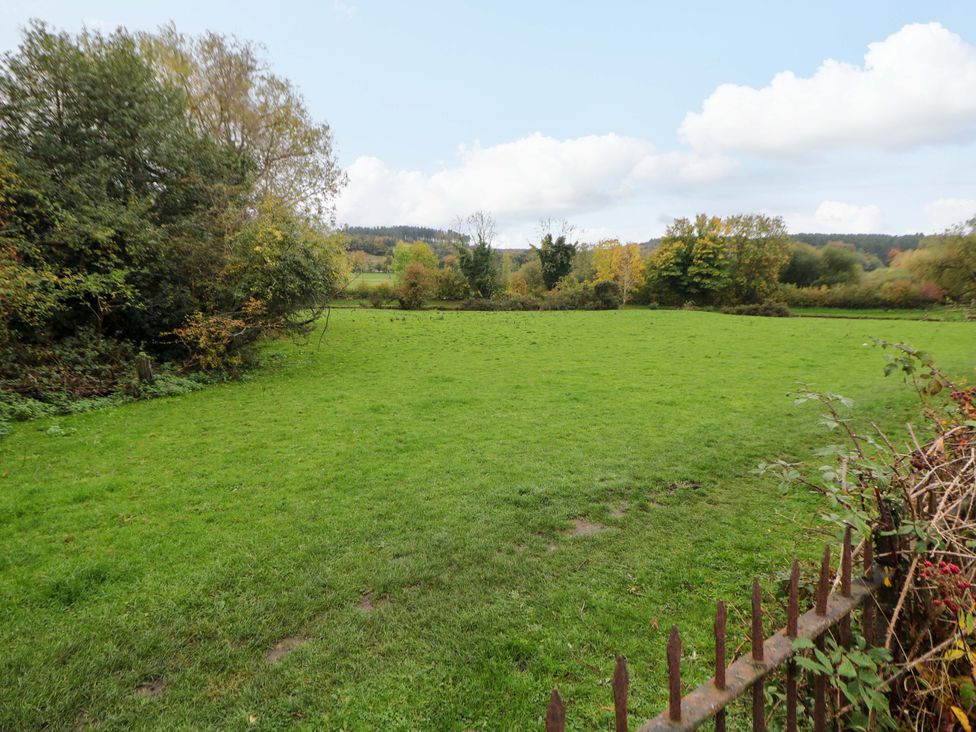 A grassy area with trees and a fence at Shunter’s Nook Stafford
