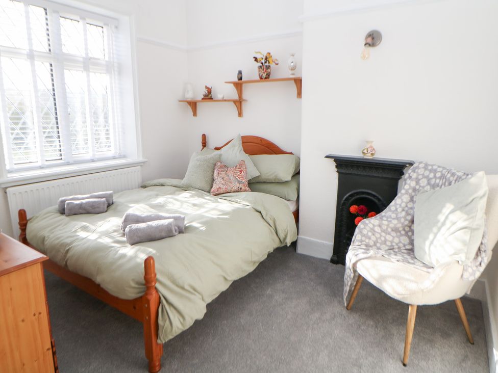 A bedroom with a bed and a chair at Shunter’s Nook in Colwich