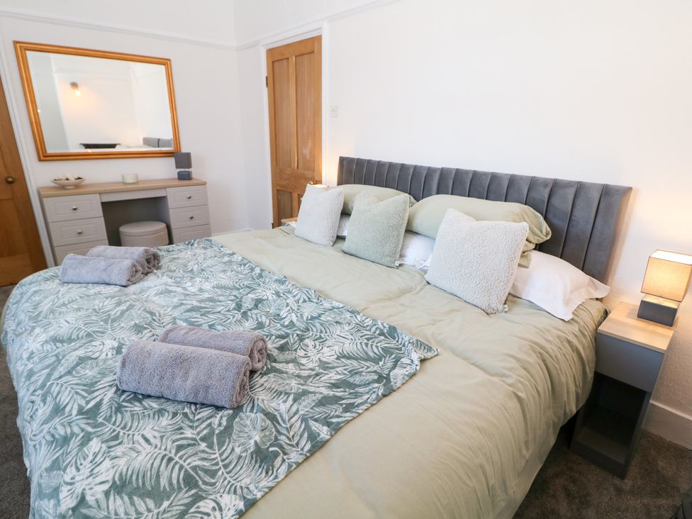 A bedroom with a bed and dresser at Shunter’s Nook in Colwich