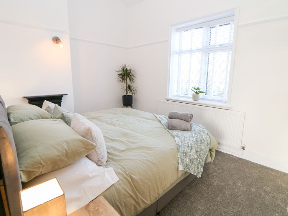A bedroom with a bed and plants at Shunter’s Nook in Colwich