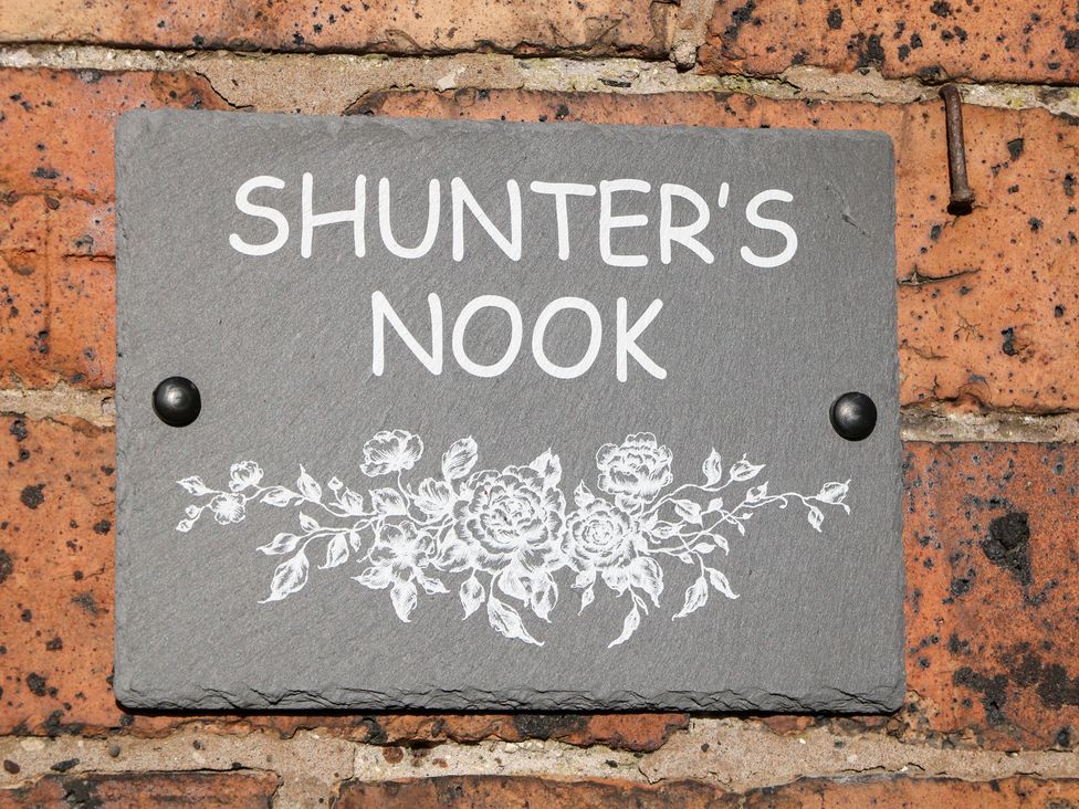 A sign that says Shunter's Nook on a brick wall in Colwich