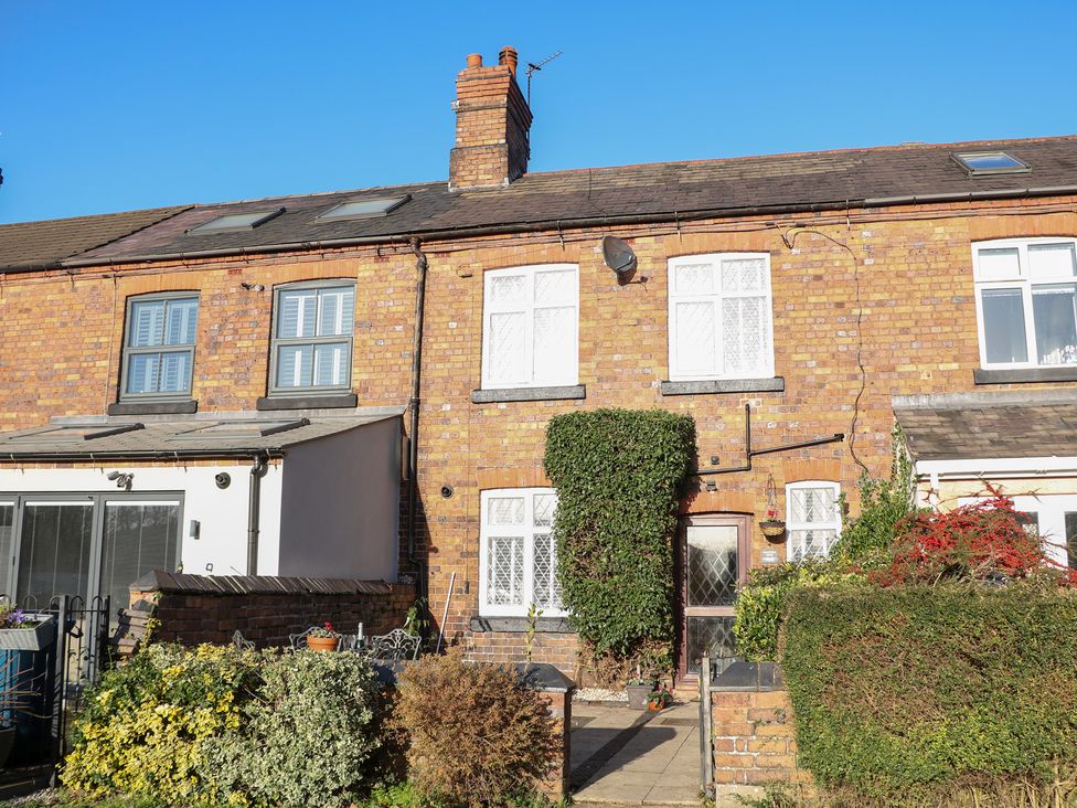 A brick house with windows and doorway at Shunter’s Nook in Colwich