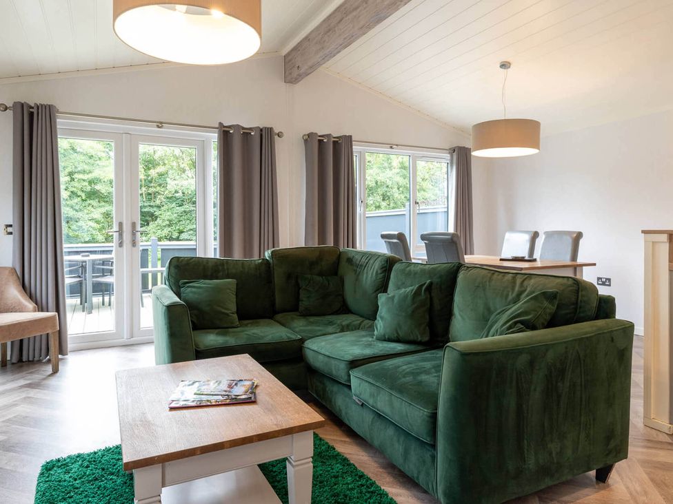 A living room with a green sofa and coffee table at Wensleydale in Aysgarth
