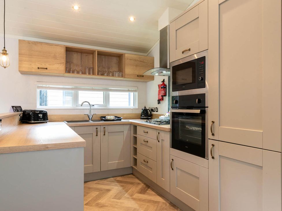 A kitchen with cabinets and appliances at Wensleydale in Aysgarth