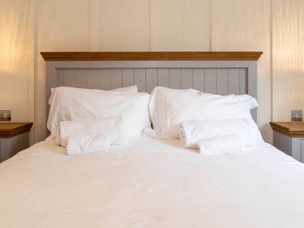 A bed with pillows and towels in a bedroom at Wensleydale Aysgarth